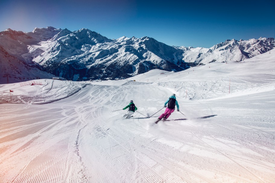 Two skiers in a resort in Switzerland