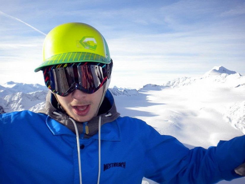 Snowboarder posing in the mountains