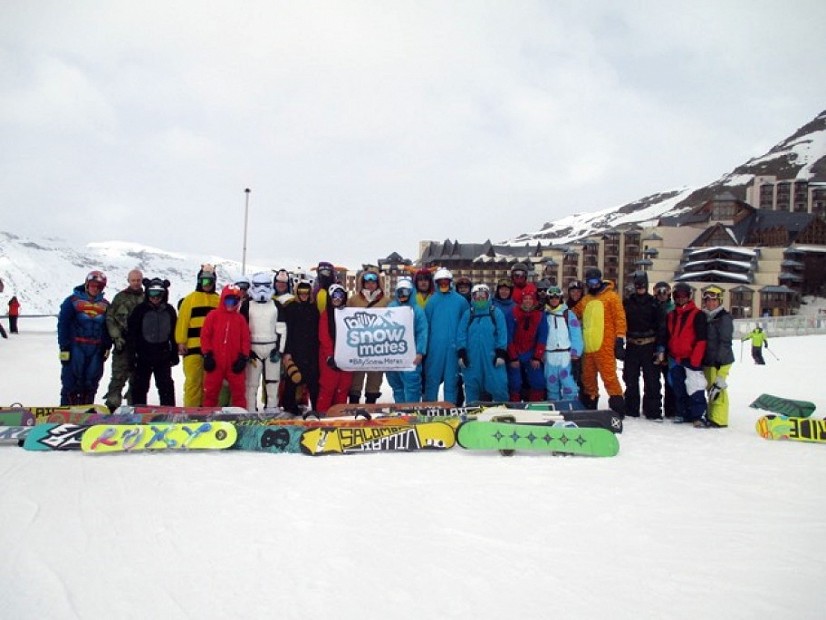 Group of snowboarders posing for photo in the mountains