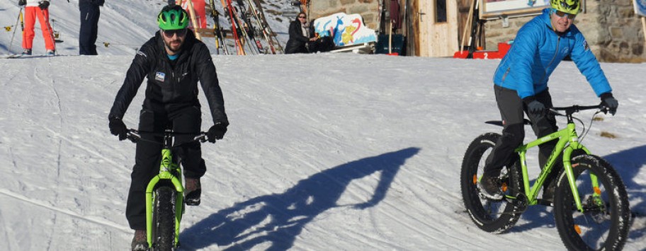 Two cyclists on snow