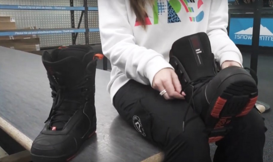 Person tying up snowboard boot laces