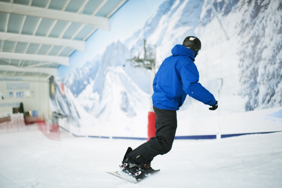 Person snowboarding in an indoor slope near London