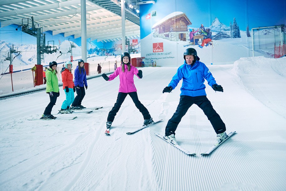 Instructor with adult group ski lesson in an indoor slope near London