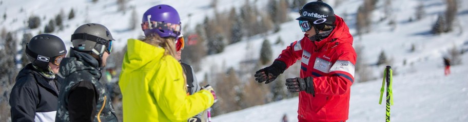 People being taught how to ski on mountain