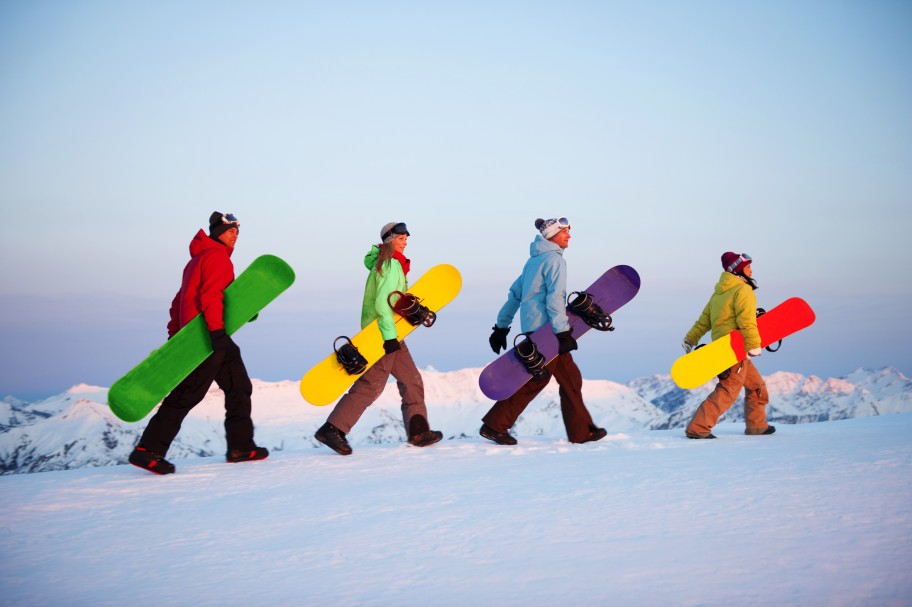 Group of walking snowboarders
