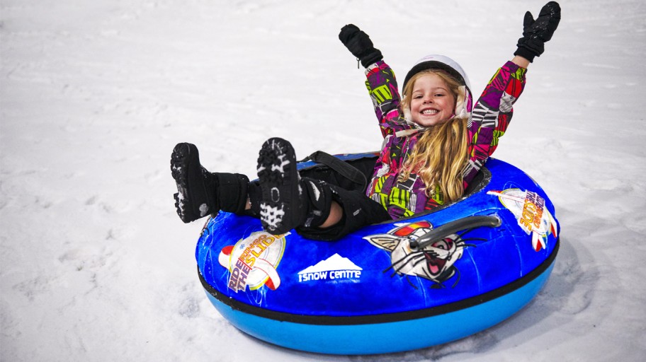 Girl having fun in a rubber ring on the slopes