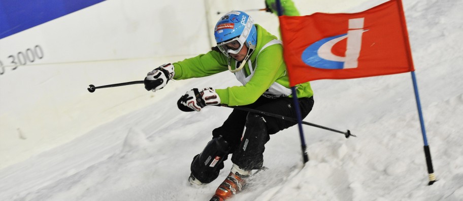 Person skiing slalom gates on downhill slope