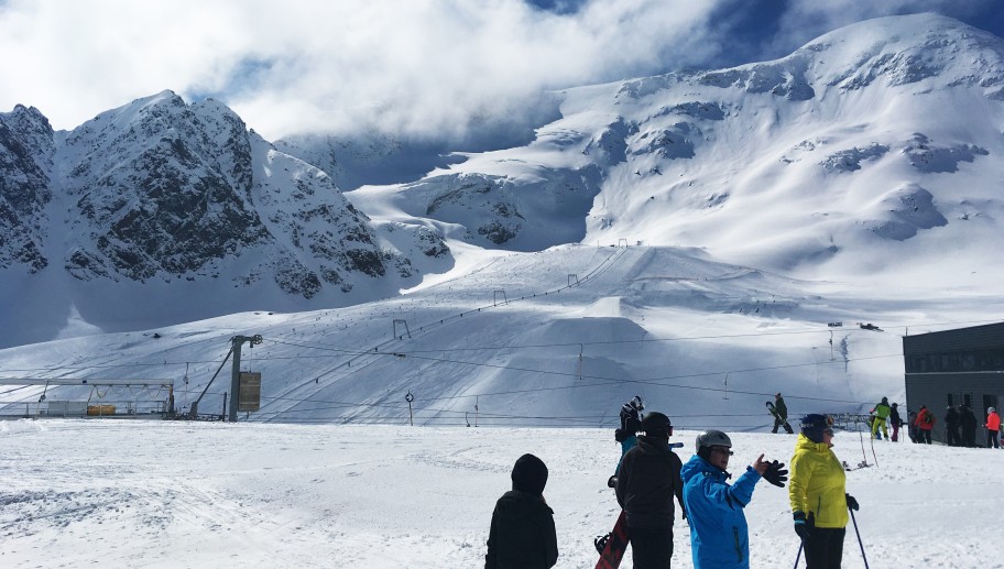 Group of ski and snowboarders on the snowy mountains