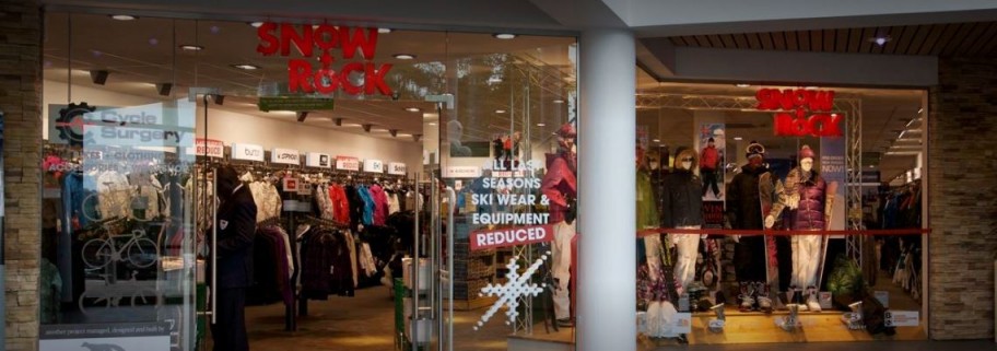 Shop window with skis and snowboards on display