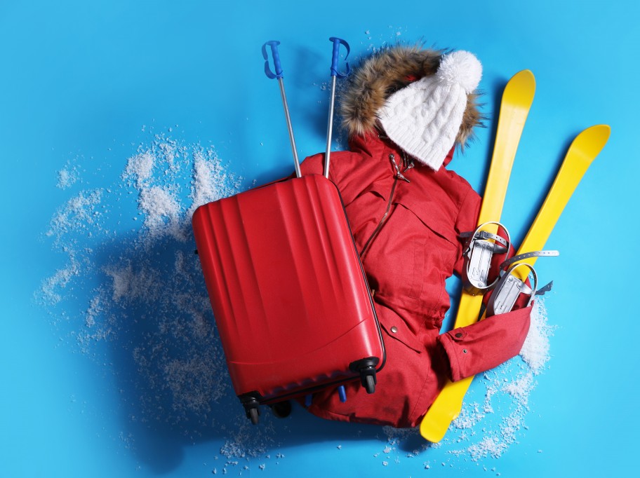 Items to take on your ski holiday - suitcase, jacket, bobble hat, skis