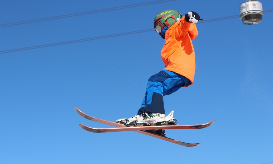 young skier performing a jump